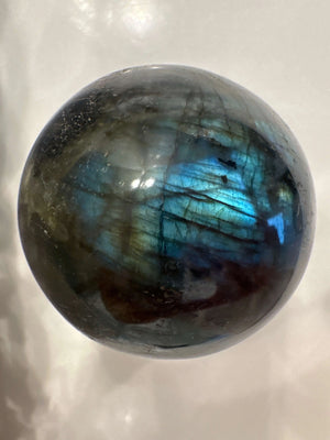Labradorite sphere showing blue and green flash