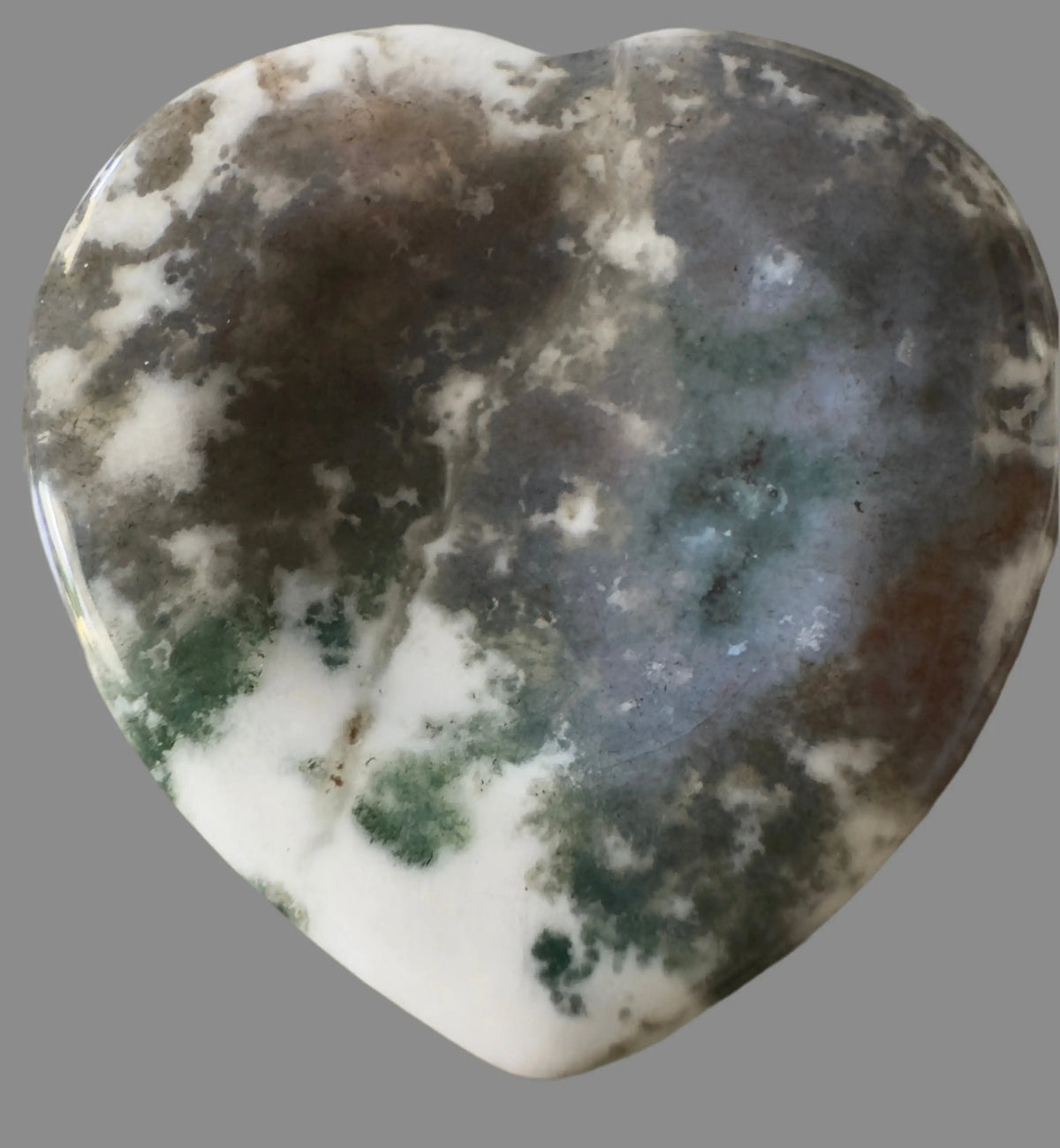 Polished heart-shaped moss agate stone with white, green, and gray inclusions.