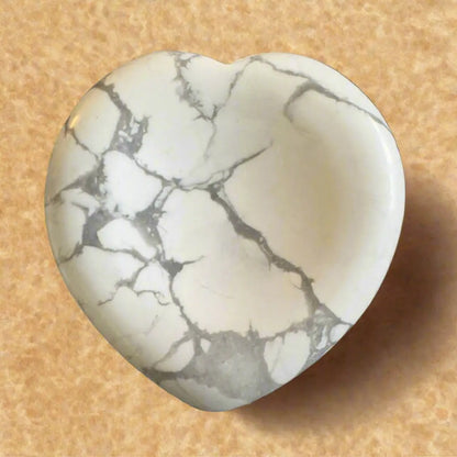 Heart-shaped howlite gemstone with gray veining.
