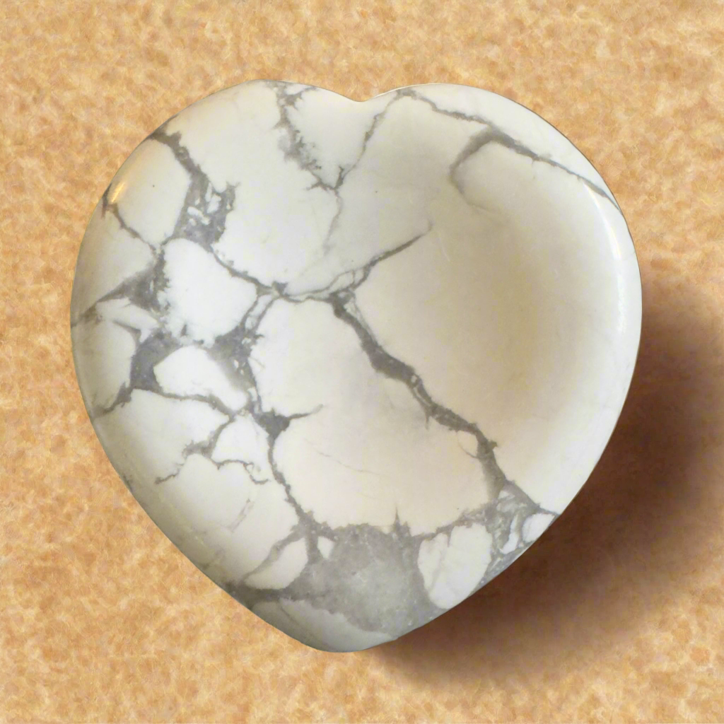 Heart-shaped howlite gemstone with gray veining.
