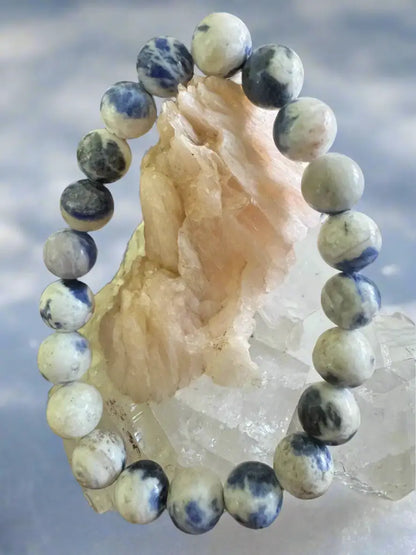 Sodalite 9mm bead bracelet on pale pink crystal cluster