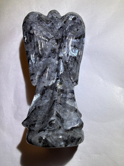 photo of back larvikite crystal detailed hand carved angel with labradorescence light reflection