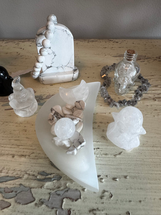 Collection of white crystals and stones on a weathered surface.