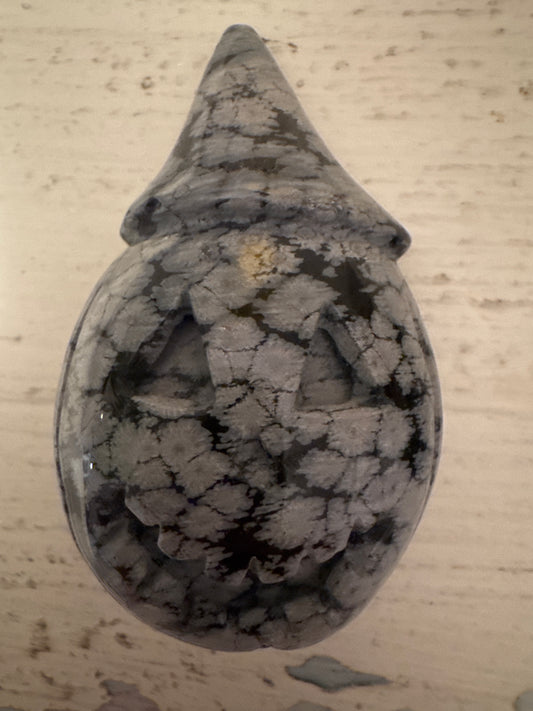Snowflake obsidian jack-o'-lantern with pointed hat.
