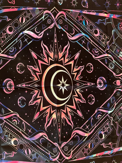 Mystical patterned fabric tapestry with central sun, moon, and star motif in pink, blue, and white on black.