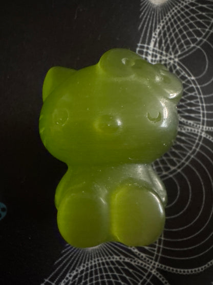 Green gummy Hello Kitty figurine.