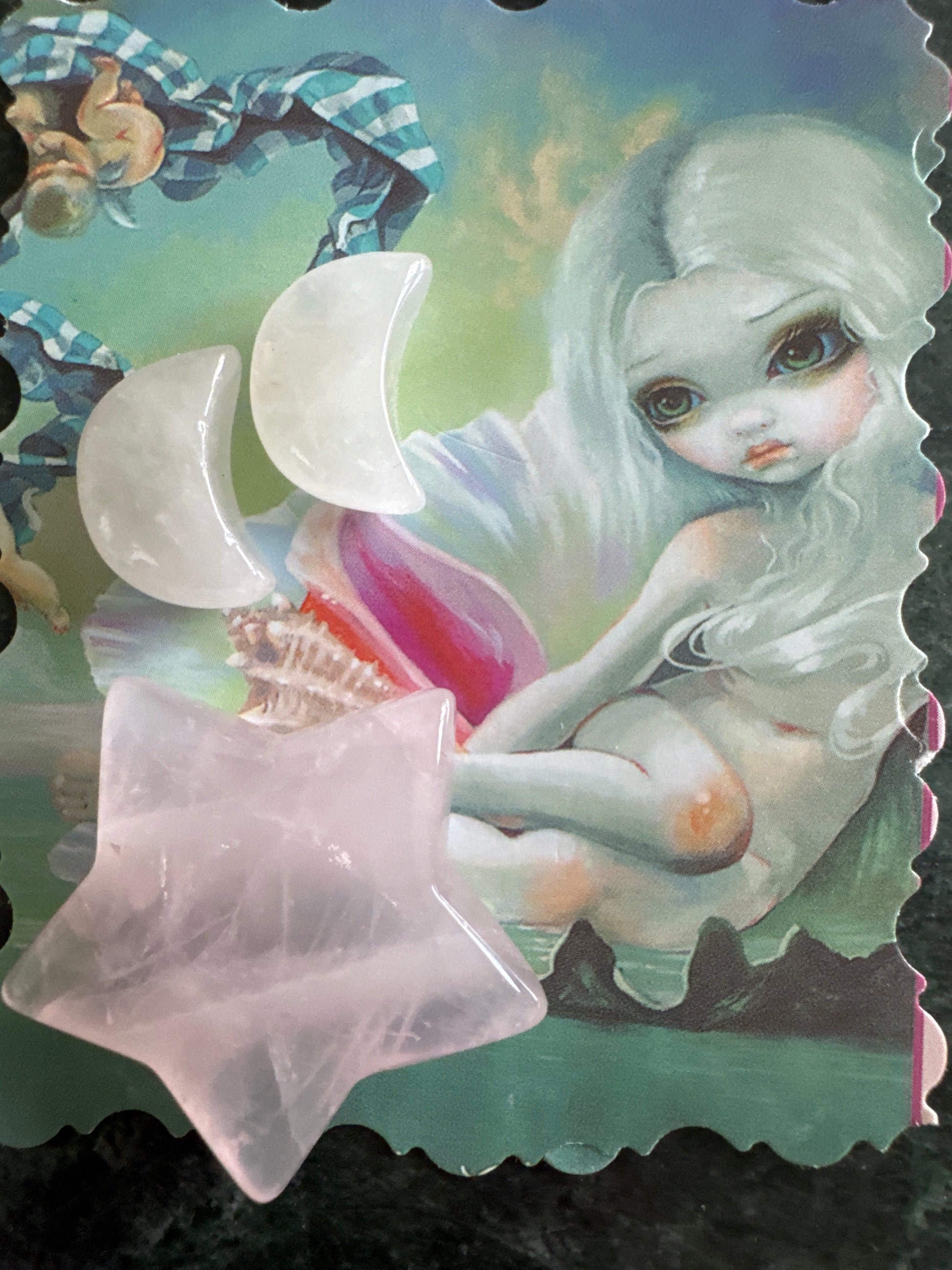 Illustration of a girl with white hair, holding white crescent moon stones and a pink star stone.