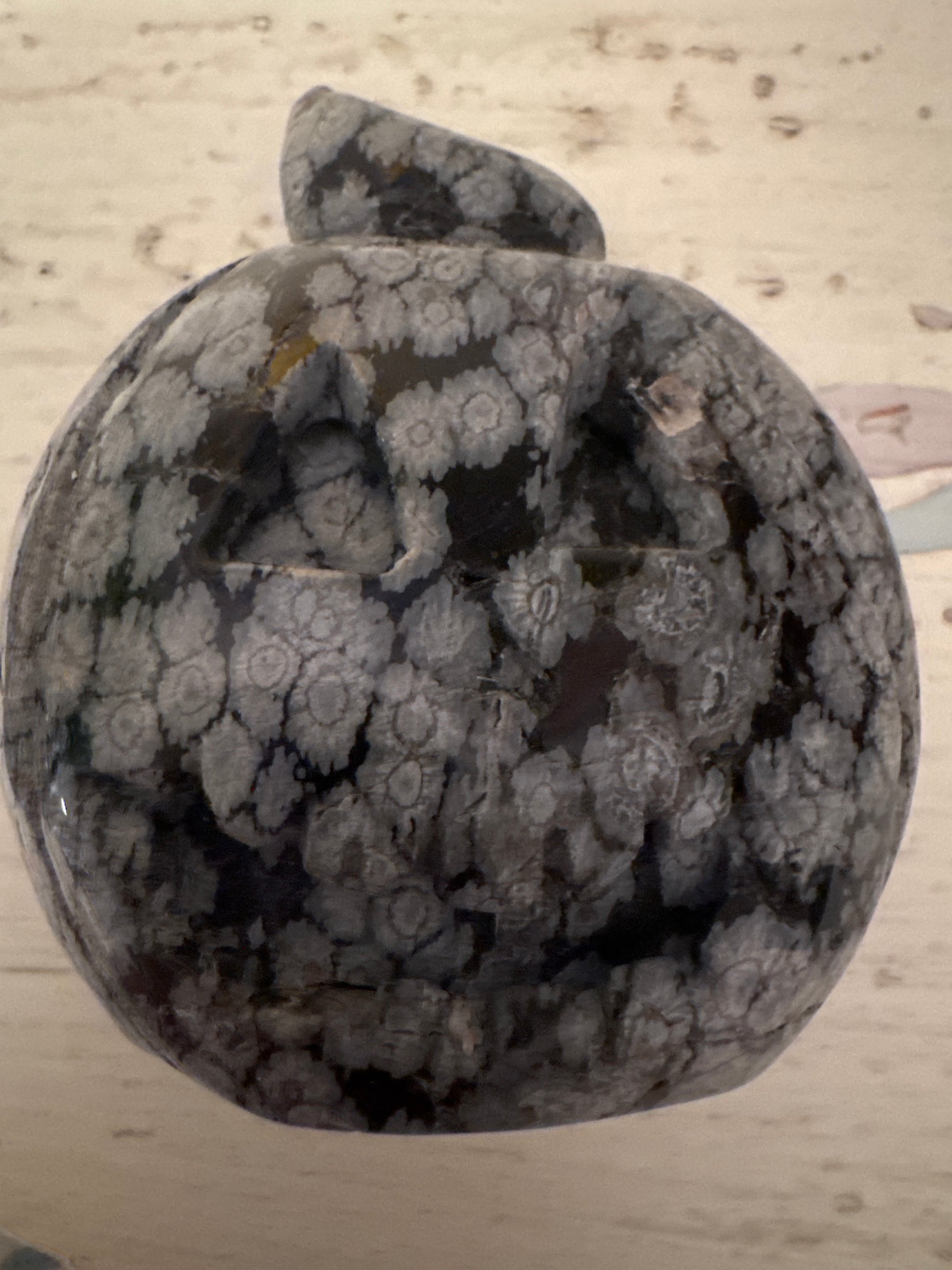 Carved snowflake obsidian pumpkin with stem.