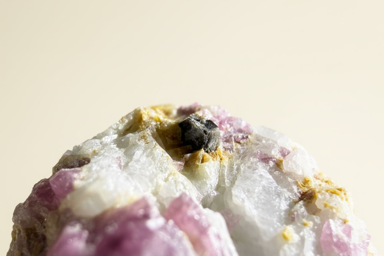 Close up of inclusion in elbaite tourmaline specimen. black mineral