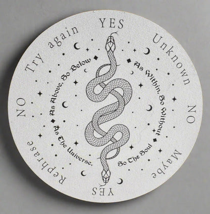 White round spirit board with black text, images of stars, moons, and a snake.