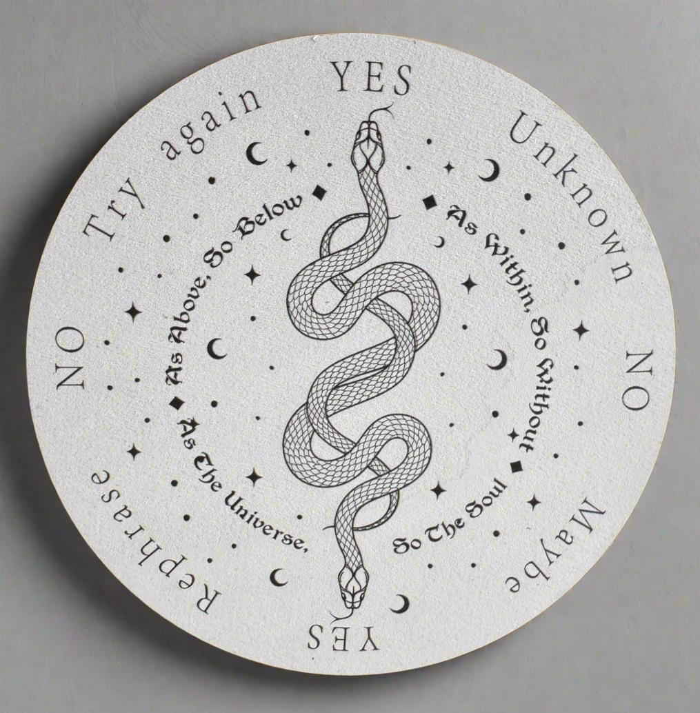 White round spirit board with black text, images of stars, moons, and a snake.