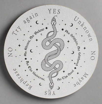 White round spirit board with black text, images of stars, moons, and a snake.