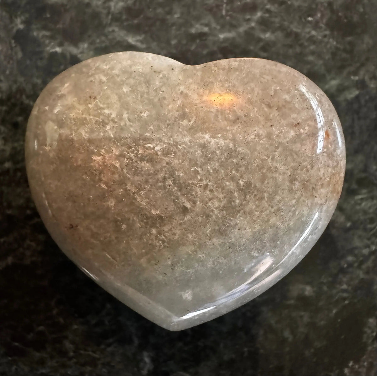 carved crystal heart on a green surface