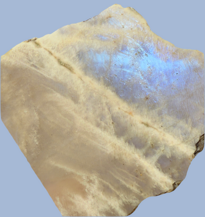 Close-up view of a moonstone slab with a light beige and blue iridescent surface.