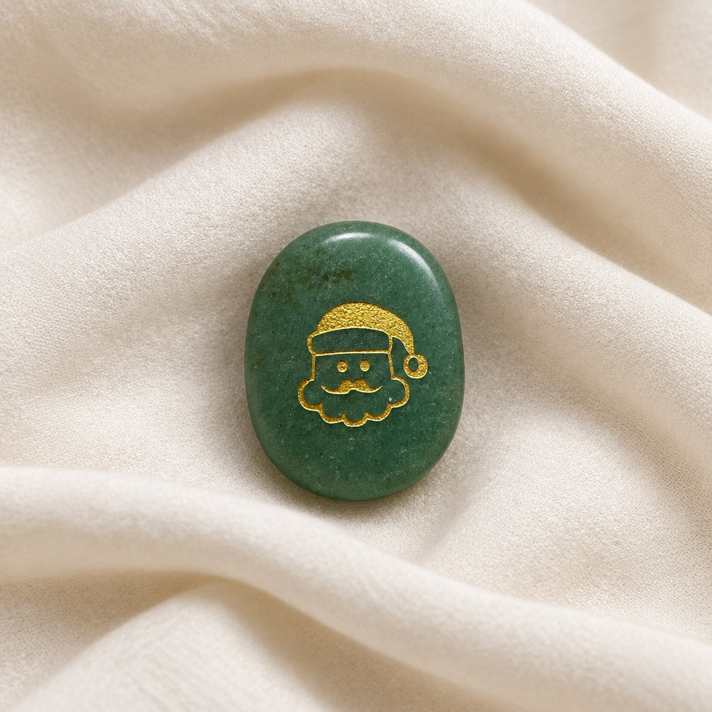green aventurine oval shaped worry stone with a santa face on one side in a gold tone color. 
