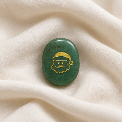 green aventurine oval shaped worry stone with a santa face on one side in a gold tone color. 