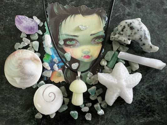 Shells and Starfish charm bag pieces on green marble surface