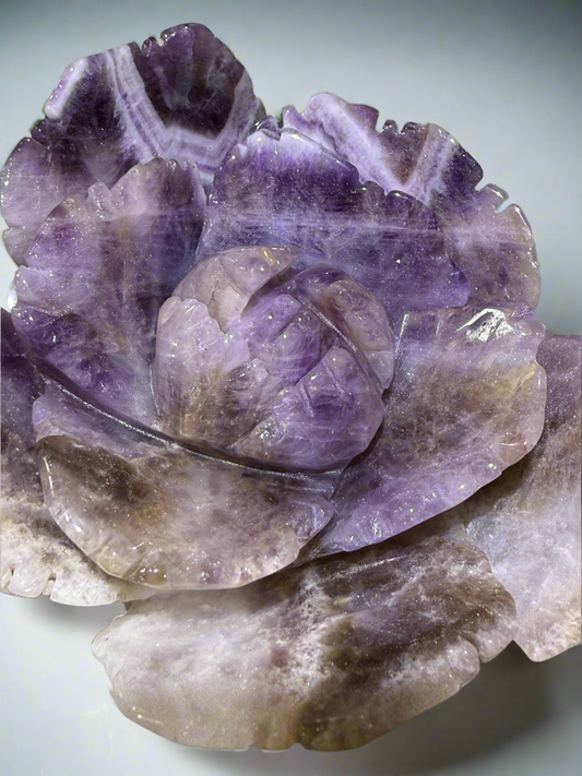 Hand-carved amethyst crystal flower with natural purple hues, offered by Mainstreet Crystals and Minerals for spiritual harmony 