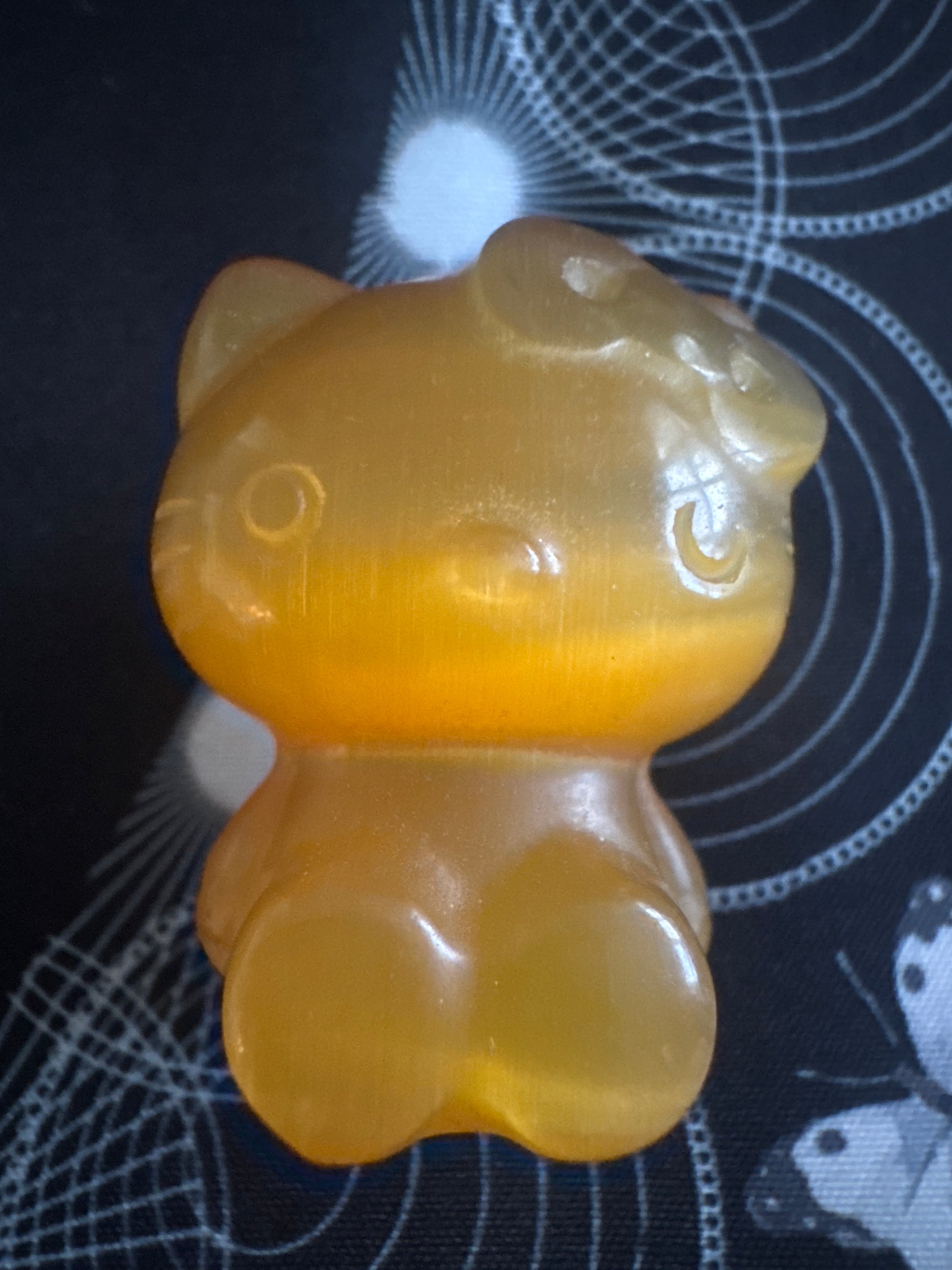 Translucent yellow Hello Kitty figurine.