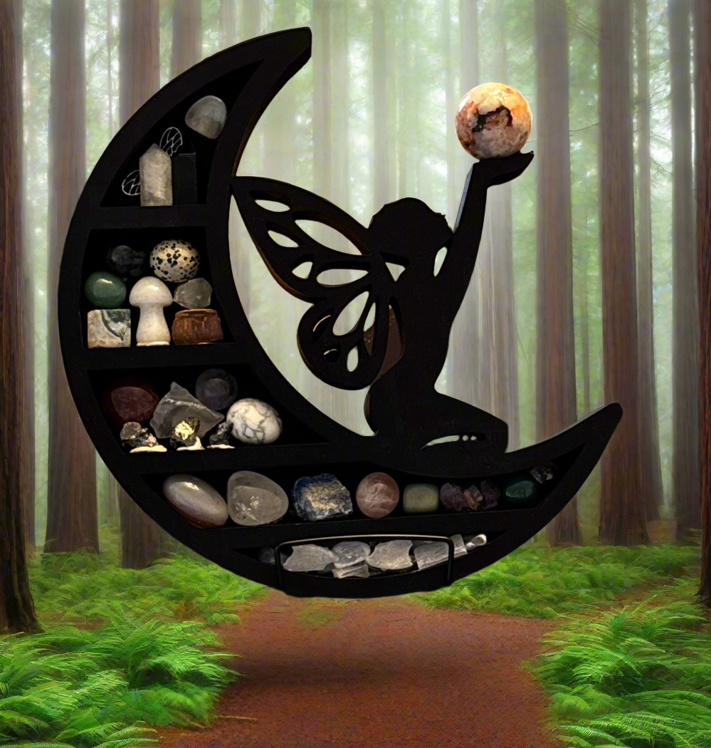 Black moon-shaped shelf filled with rocks and crystals, with a silhouette of a fairy holding a sphere on top, set in a forest.
