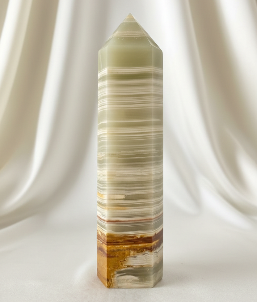 A tall, polished Afghanistan jade tower  with horizontal banding in cream, beige, and amber-brown tones