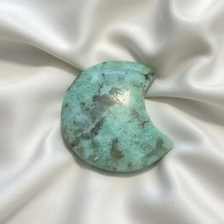 Close up of polished carved amazonite crescent moon 