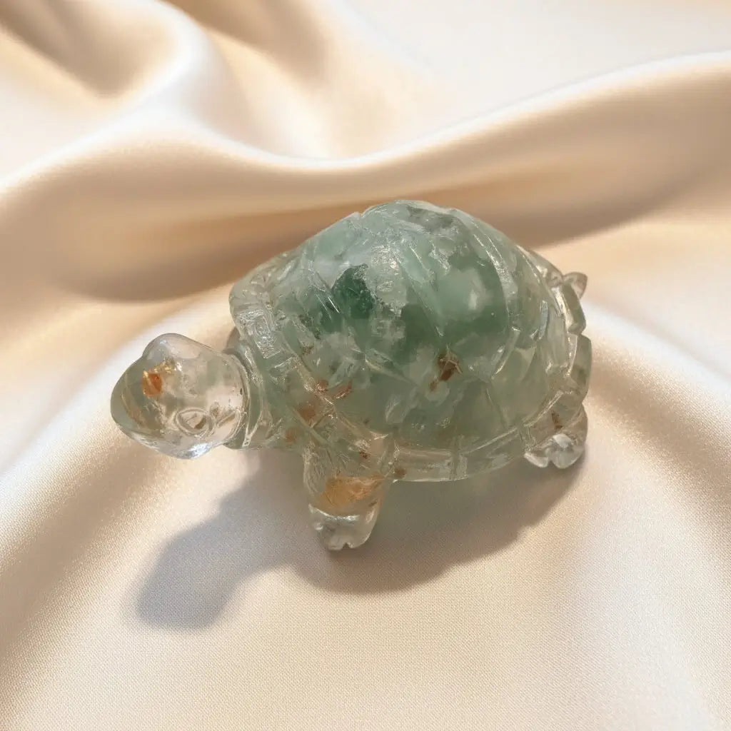 close up looking down of orgone resin turtle filled with amazonite gravel and copper shavings 