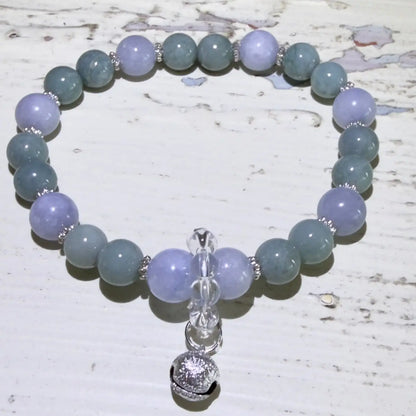 8.45mm angelite beads, 7.45mm aventurine beads, clear quartz beads and a silvery protection bell.  beautiful soft blues and greens, 
