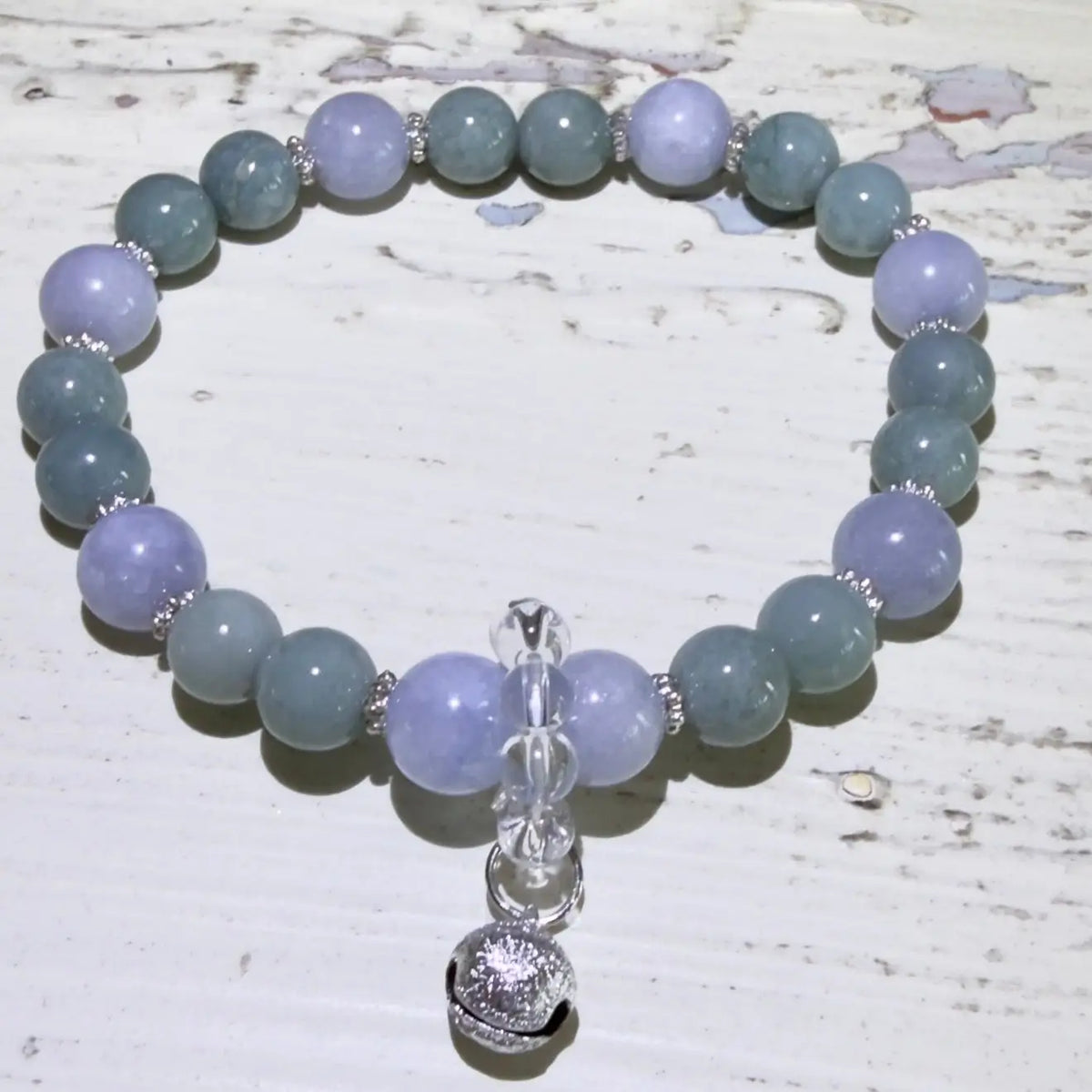 8.45mm angelite beads, 7.45mm aventurine beads, clear quartz beads and a silvery protection bell.  beautiful soft blues and greens, 
