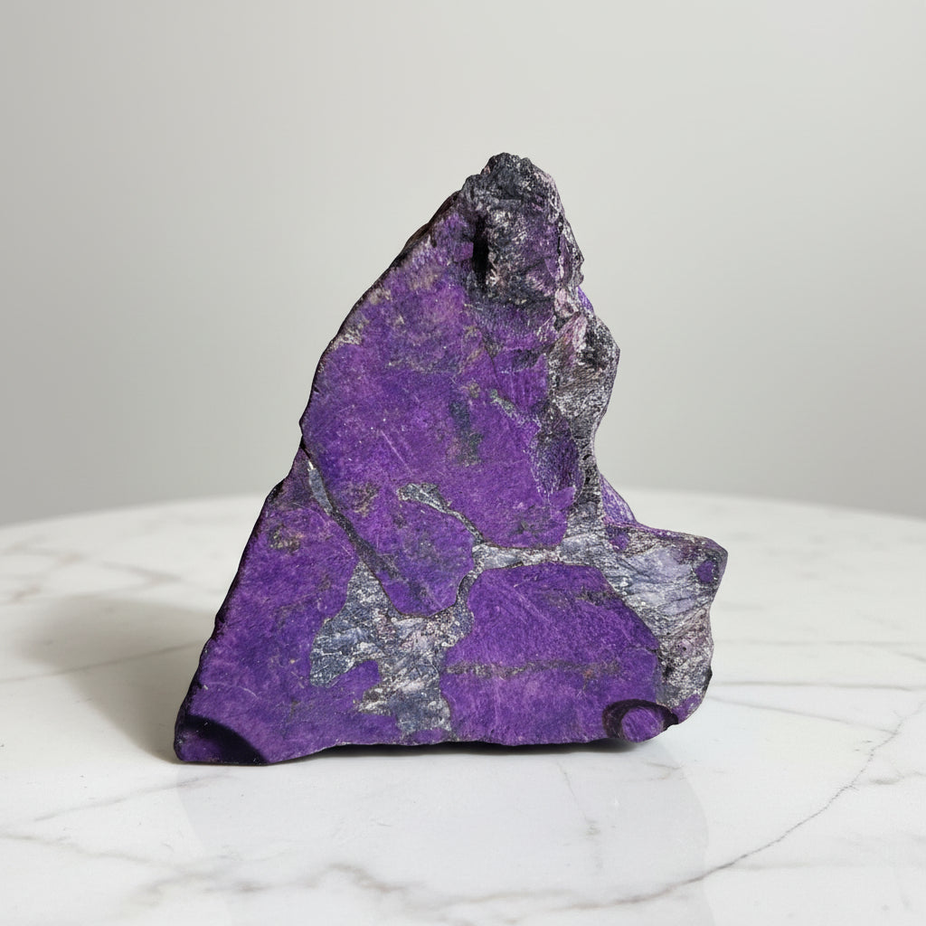 Close-up atlantisite raw gemstone bright purples and green 