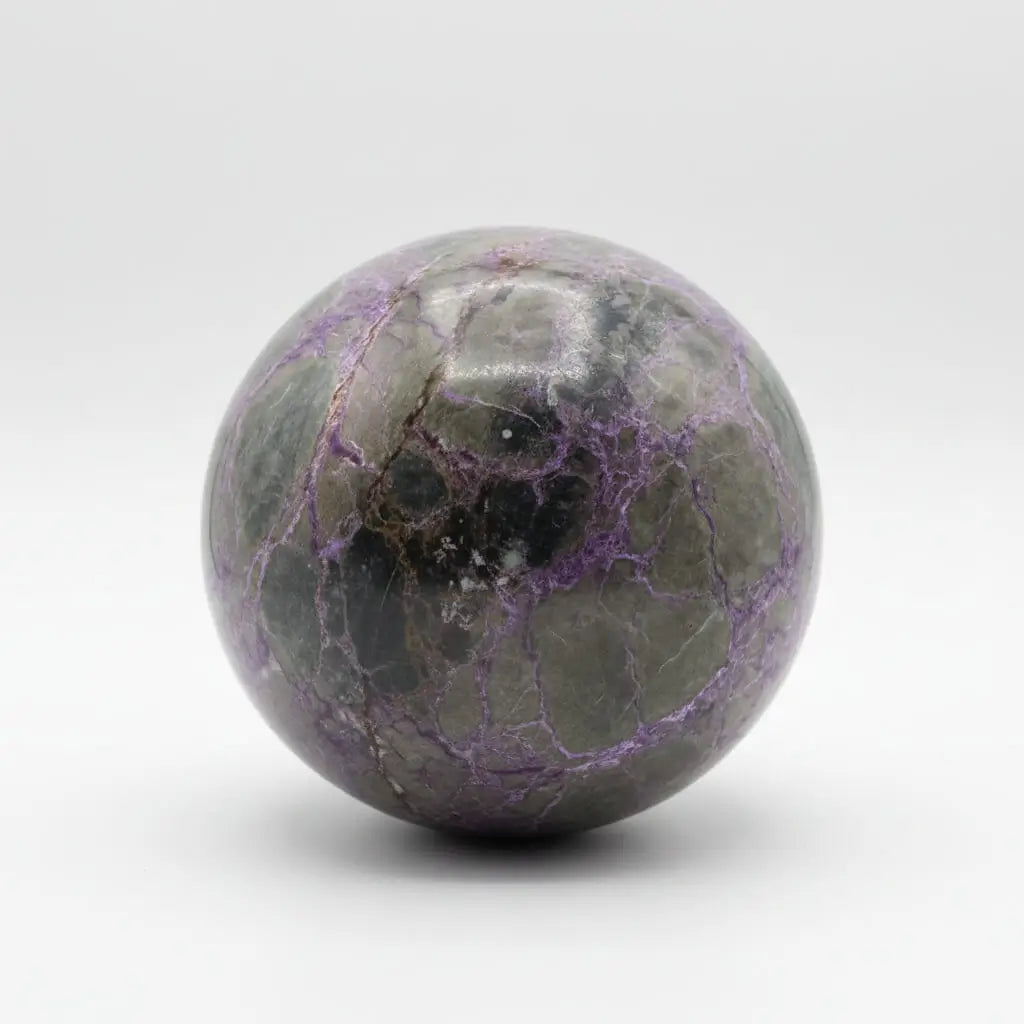 Atlantisite sphere white background brilliant purples and green 