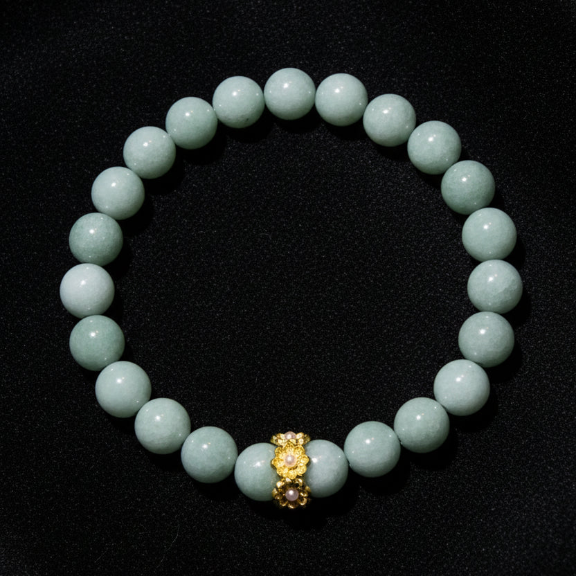A beaded bracelet made of Aventurine  round beads with a small gold-toned decorative charm at the center, 8mm beads