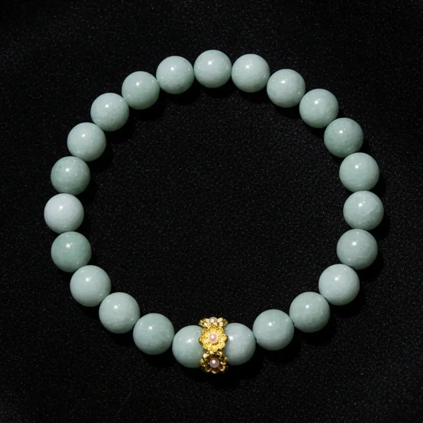 A beaded bracelet made of Aventurine  round beads with a small gold-toned decorative charm at the center, 8mm beads