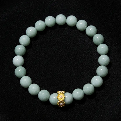 A beaded bracelet made of Aventurine  round beads with a small gold-toned decorative charm at the center, 8mm beads