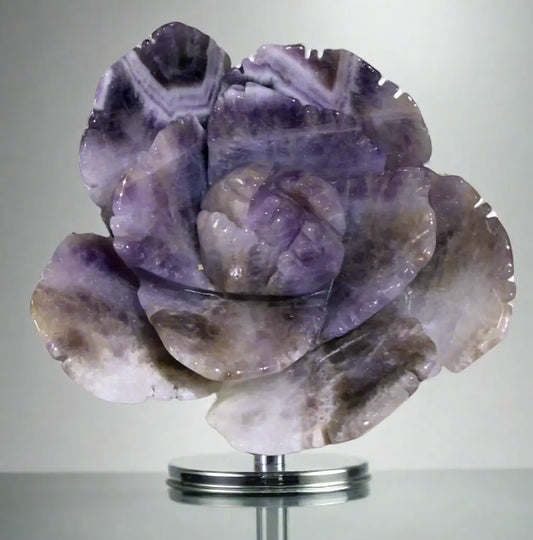 Close up of amethyst crystal carved into shape of lotus flower. bright purples 