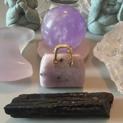 close-up calming crystal bundle lepidolite handbag, amethyst sphere, clear quartz raw, fluorite crescent moon
