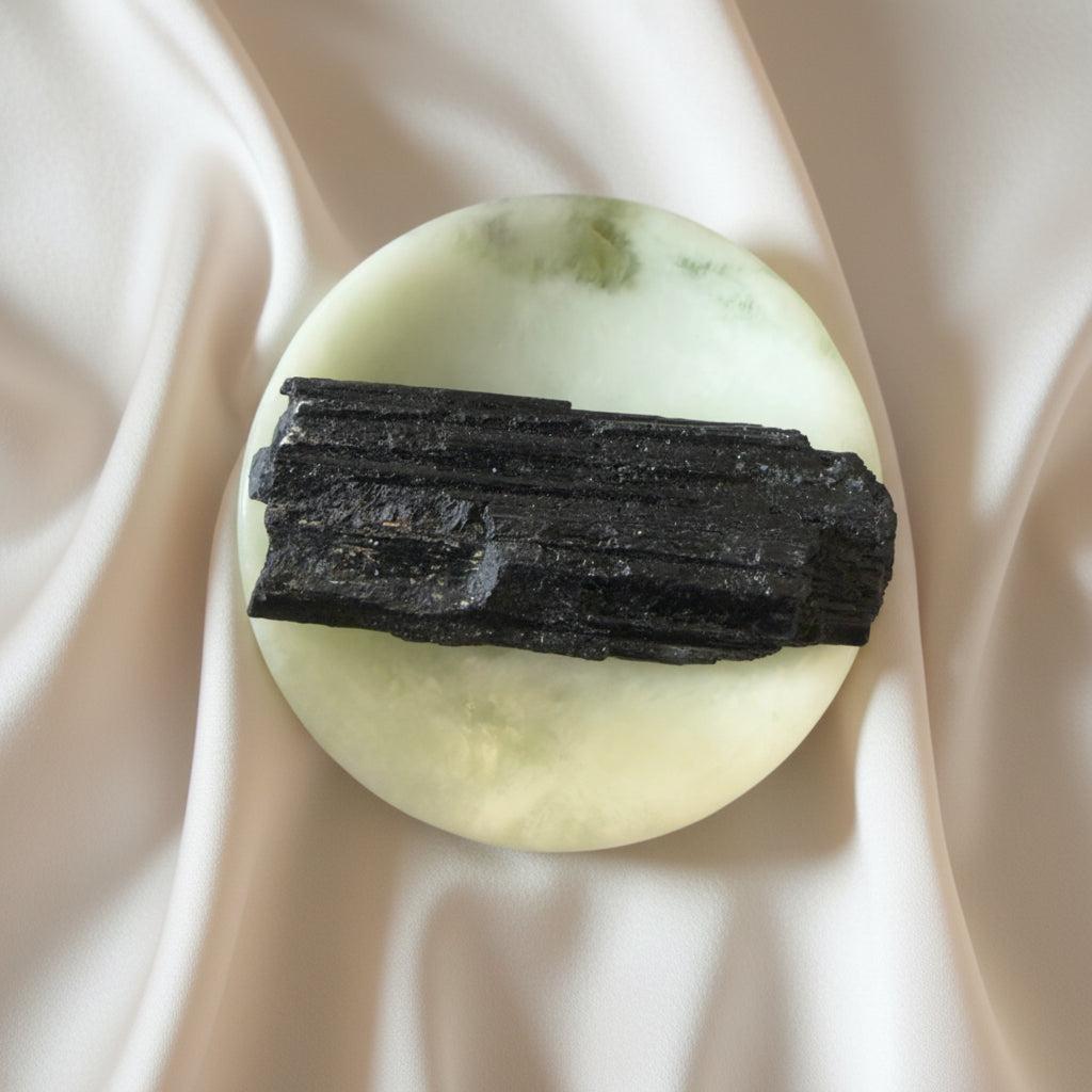 Black Tourmaline rough gemstone in a green serpentine carved bowl 