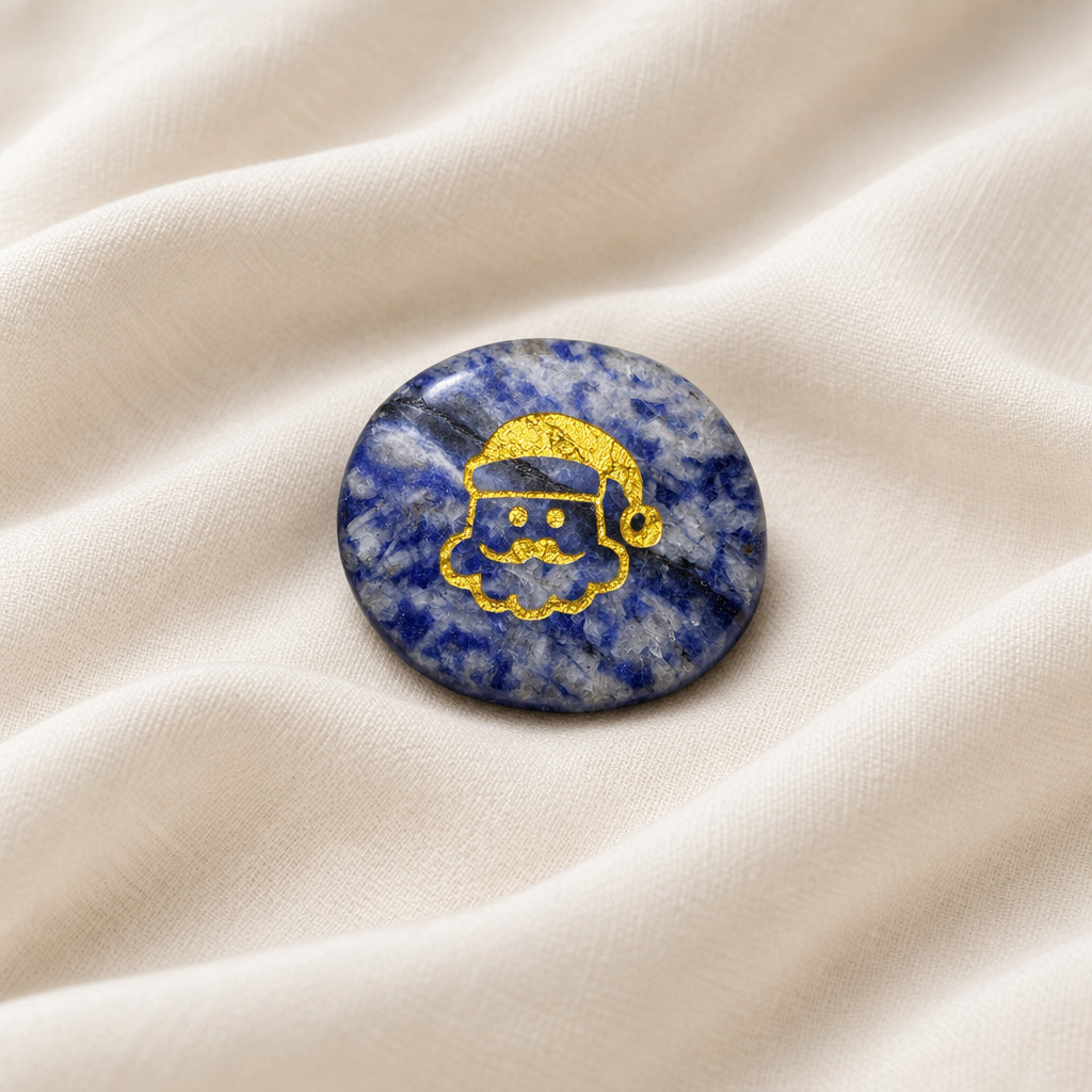 Carved worry stone made from sodalite with etched santa in gold color