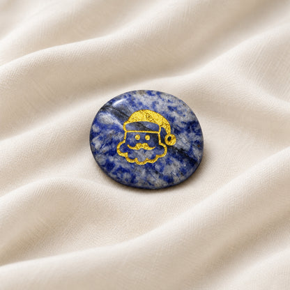 Carved worry stone made from sodalite with etched santa in gold color