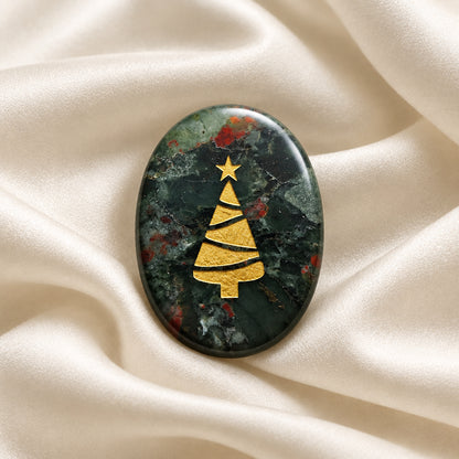 Carved worry stone made from Bloodstone crystal, a christmas tree etched on one side in a gold tone