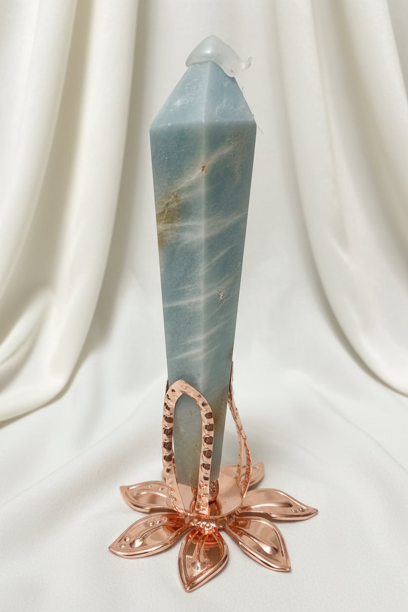 close up caribbean calcite wand tower in a rose tone stand  wand has tip protector