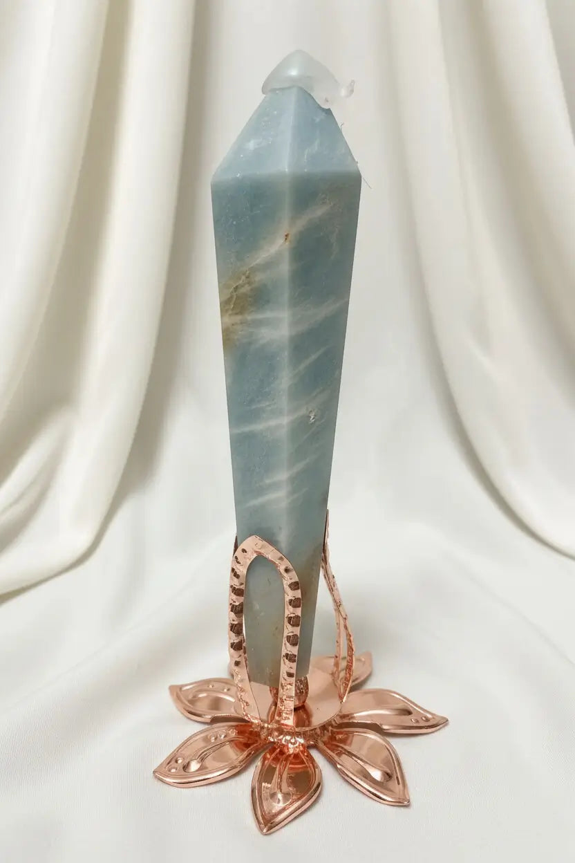 close up caribbean calcite wand tower in a rose tone stand  wand has tip protector