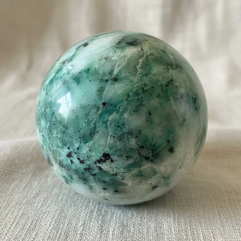 close up of chrysocolla sphere showing blues and quartz