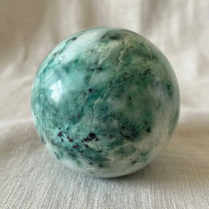 close up of chrysocolla sphere showing blues and quartz