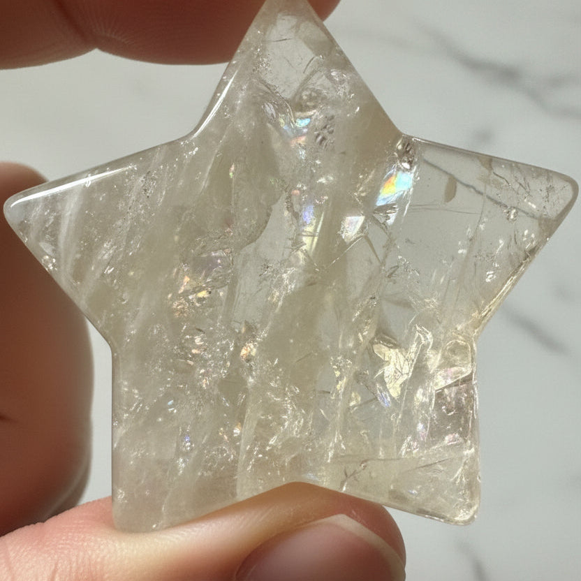 close up of citrine carved heart in natural light showing rainbows
