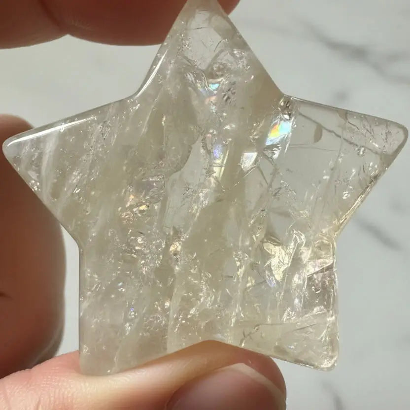 close up of citrine carved heart in natural light showing rainbows