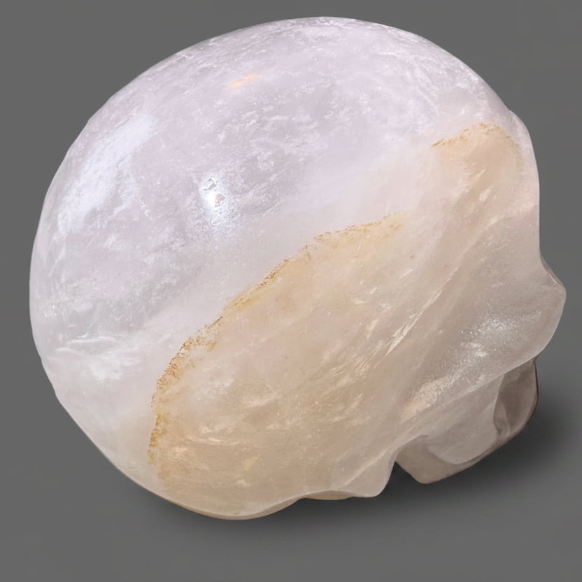 hand carved clear quartz skull with golden healer inclusions 