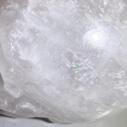 close up clear quartz hand carved skull with rainbows 