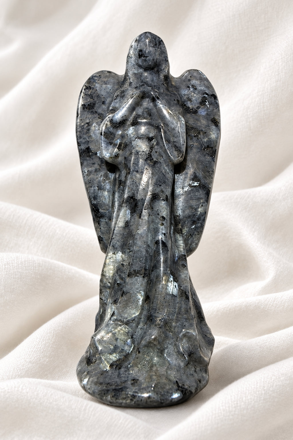 photo of larvikite hand carved angel. shows amazing detail and schiller