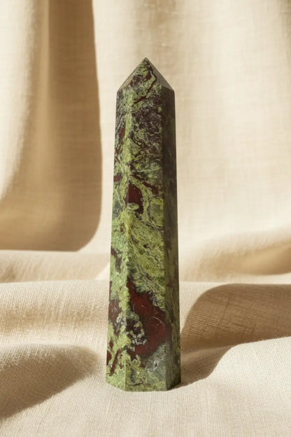 Polished Dragon’s Bloodstone Tower showing beautiful deep forest green epidote and red piemontite, background brown burlap fabric
